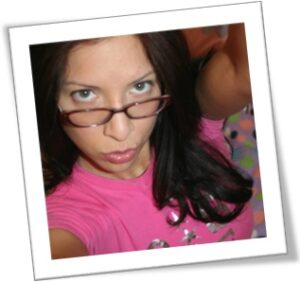 Phone Sex Teen Honey peering over her glasses pouting her lips waiting for you to call her.